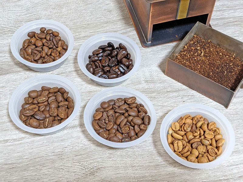 Different coffee beans showcasing various roast levels and selection stages